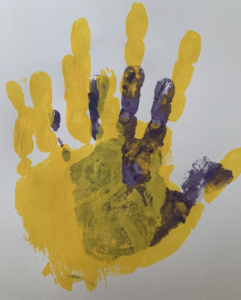 Overlapping yellow and purple handprints